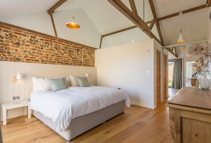 Big Sky Barn, Ridlington: Enjoy the exposed beams and brickwork in bedroom one