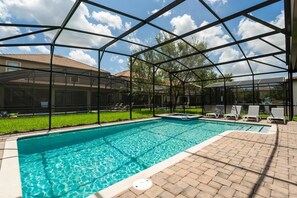 Relax in your private screened pool oasis with a hot tub and sun loungers, perfect for soaking up the sun in style.