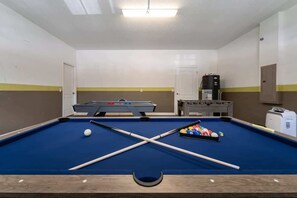 Unwind in our vibrant game room featuring pool, air hockey, and foosball for endless fun!
