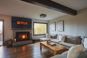 Large picture windows allow the most lovely viewing of the seasons, creating a welcoming atmosphere for relaxation and gatherings.