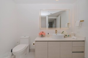 Refresh in the elegant private bathroom with hot water, an LED-lighted mirror, and premium amenities for a spa-like experience during your stay.