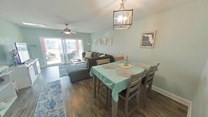 Open-concept living room and dining area. Dining table with 4 seating's.