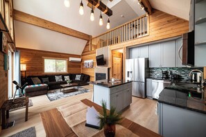 Open living room with electric fireplace and TV