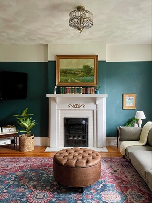 Vibrant living room greets you as you walk in. Enjoy a movie on the 55" Roku TV.