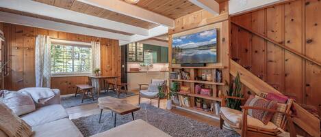 Open concept living room and dining area with fireplace and smart tv! 