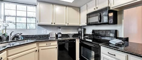 Kitchen with microwave, stove/oven, fridge, dishwasher, utensils etc