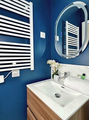 A well equipped bathroom with shower