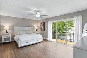 The inviting master's bedroom offers an outdoor deck access with just a few steps.