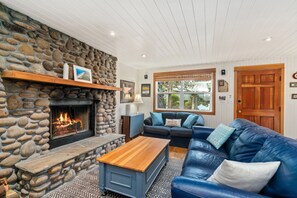 Living room with Roku TV, Fireplace and open to the kitchen and dining area.