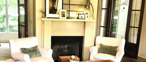 Living room with French doors leading to screened porch 