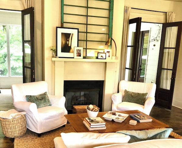 Living room with French doors leading to screened porch 