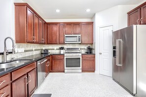 Well stocked large kitchen with full sized pantry. 