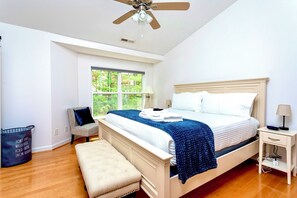 Primary bedroom with 42” smart TV and private full bath, dual vanity