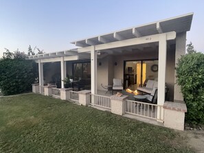 Private back patio on golf course with mountain and sunset views.