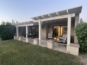 Private back patio on golf course with mountain, palm trees and sunset views.