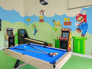 Garage converted into game room with a mario theme.  Enjoy hours of fun playing Shuffleboard, Air Hockey, Roll n Score, Table Tennis and Arcade games.