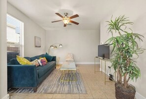 Enjoy ultimate relaxation and comfort in this cozy living room w/ Smart TV.
