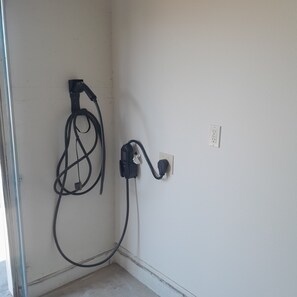 cord for EV charging located on the inside wall of the garage