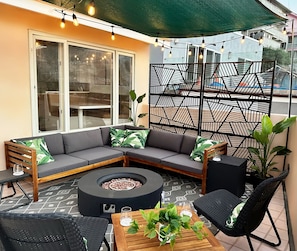 Experience pure enchantment on our patio lounge with twinkle lights & a firepit!