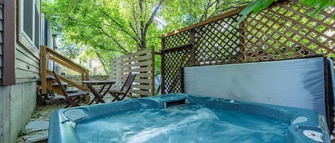 Unwind in Your Private Oasis: enjoy a soothing soak in the backyard of the home right out the back door