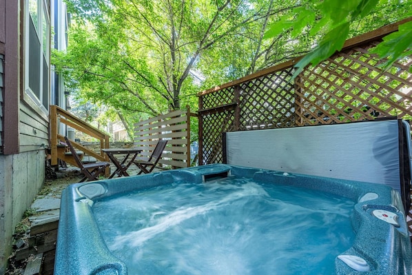 Unwind in Your Private Oasis: enjoy a soothing soak in the backyard of the home right out the back door