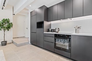 Indulge in culinary delights with our fully equipped, contemporary kitchen space.