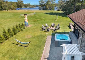 Waterfront Cottage Hot tub and fire pit adjacent to screened in veranda 