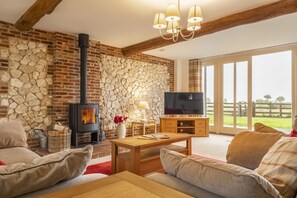 6 Courtyard Barn, Docking: Sitting room with french doors to the enclosed garden