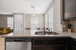 A sleek and modern kitchen with granite countertops is perfect for any home chef