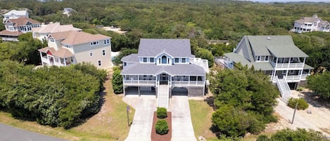 Drone - Double driveways for parking and a warm bright exterior to meet you and your guests.