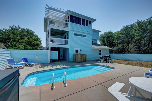 Pool Area - Comfortable poolside loungers, a gas grill, and a hot tub create the perfect poolside retreat.