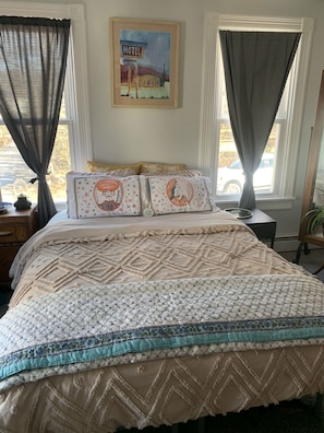 Queen bed with comfortable cotton linens from a trip to India