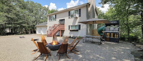 Our Front yard offers many amenities: play house, picnic table, fire pit & more.