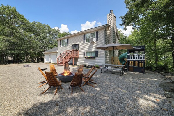 Our Front yard offers many amenities: play house, picnic table, fire pit & more.