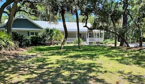 Front of Home facing the marsh among the tangled oaks & palms