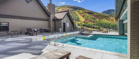 Outdoor pool just steps away from the home nestled against the mountain for extra privacy