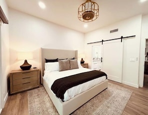 Master bedroom with smart Tv and attached master bath.