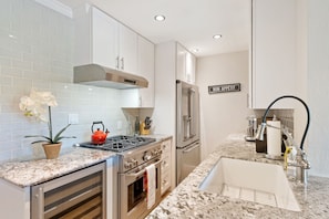 Modern kitchen with gas stove,  Nespresso and wine fridge