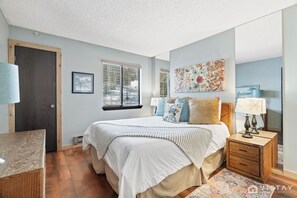 Master bedroom with a comfortable queen-size bed, perfect for a restful night's sleep.