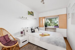 Cozy bedroom featuring a comfortable bed, colorful decor, and a relaxing ambiance.


