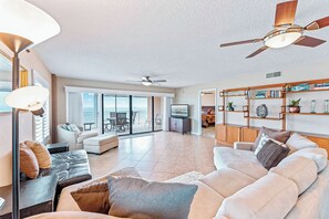 Bright and airy living area with abundant natural light and modern furnishings.