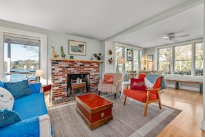 Open concept living room and dining area with water views
