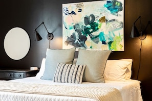 Comfortable king bed in the primary bedroom featuring a Smart TV, ensuite bath, and recently updated decor & furnishings.