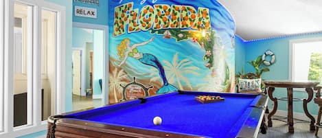 Game room with pool table and arcade and game boards