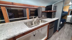 galley kitchenette with electric griddle and pan, mini fridge 