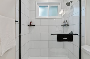 Luxury walk-in shower with amenities included.