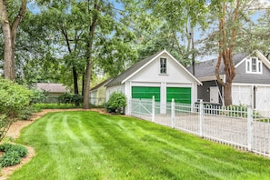 A fenced backyard that offers ample space for both relaxation and recreational activities.
