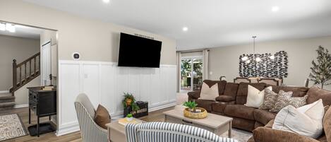 Cozy up on the couch and relax in front of the TV. This spacious living room has a comfortable couch, a large TV, and plenty of space to spread out.