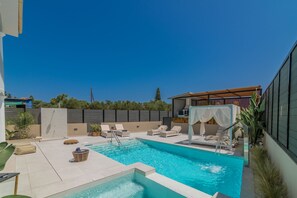 Multiple lounges are available and also an outdoor shower is next to the pool. 