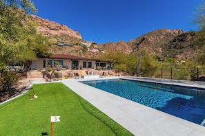 Putting green and pool, facing main home and Camelback